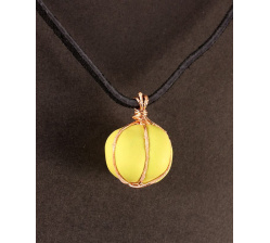 Polymer cushion bead in green with copper, on leather 