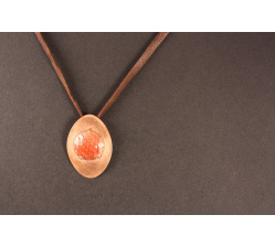 red enamelled disc in oval copper setting