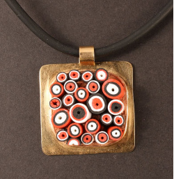 Tube mosaic in black, white and red, bronze setting