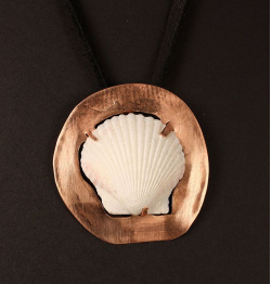 Scallop shell on copper disc