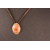 red enamelled disc in oval copper setting